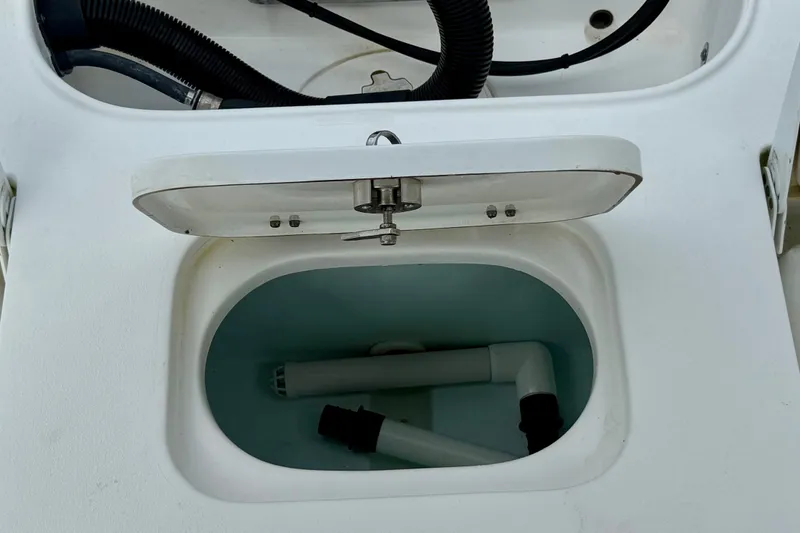 Slide: The Image of Open compartment on 2019 Sea Hunt BX 20 BR boat showing internal pipes and fittings. - 11
