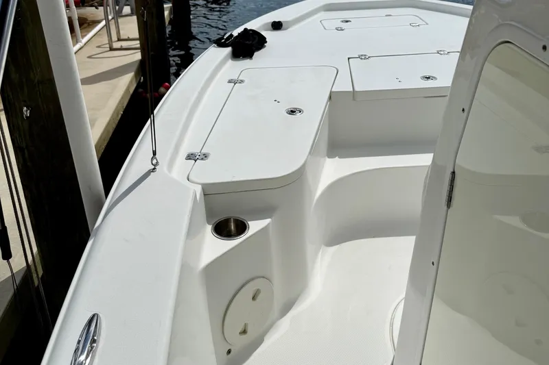 Slide: The Image of 2019 Sea Hunt BX 20 BR boat interior with storage compartments and cup holder. - 14