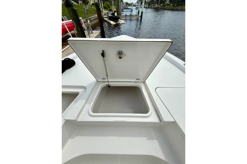 Slide: The Image of 2019 Sea Hunt BX 20 BR boat with open storage compartment by the water. - 17