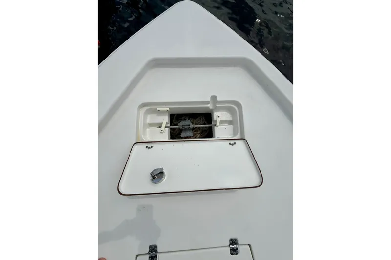 Slide: The Image of 2019 Sea Hunt BX 20 BR boat anchor storage compartment open on deck. - 18