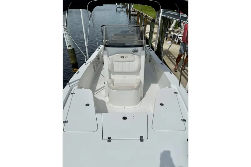 Slide: The Image of 2019 Sea Hunt BX 20 BR boat interior with seating and storage compartments. - 19