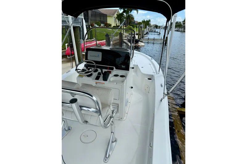 Slide: The Image of 2019 Sea Hunt BX 20 BR boat with Garmin navigation, docked by a canal. - 24