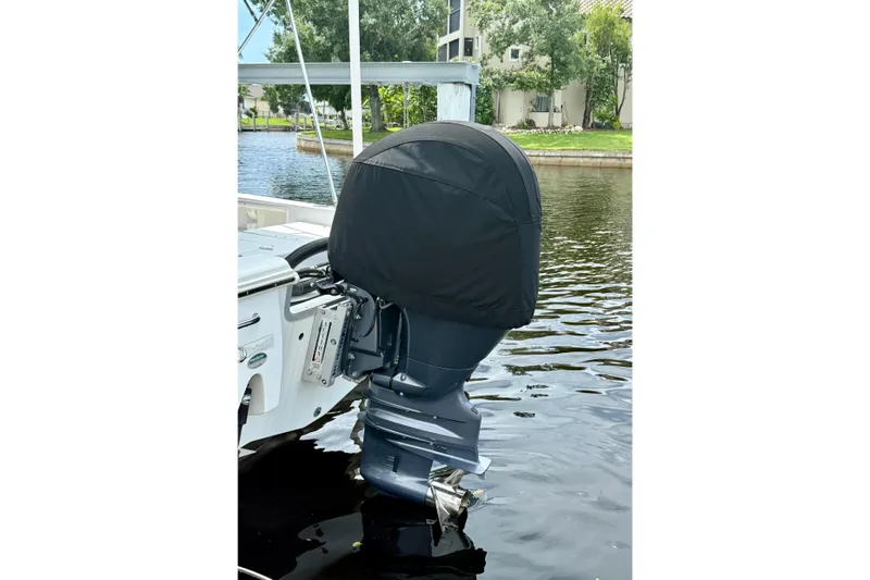 Slide: The Image of 2019 Sea Hunt BX 20 BR boat with covered outboard motor on calm water. - 35