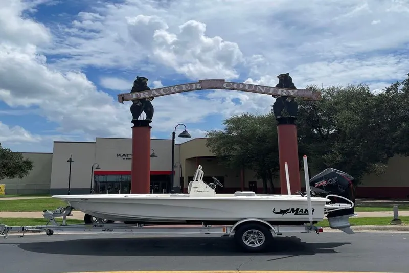 The Image of 2026 Mako Pro Skiff 18 boat on trailer, parked outdoors. - 0