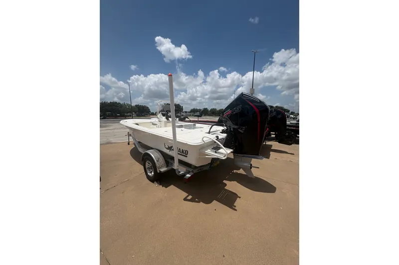 Slide: The Image of 2026 Mako 18 Pro Skiff boat on trailer under a clear blue sky. - 5