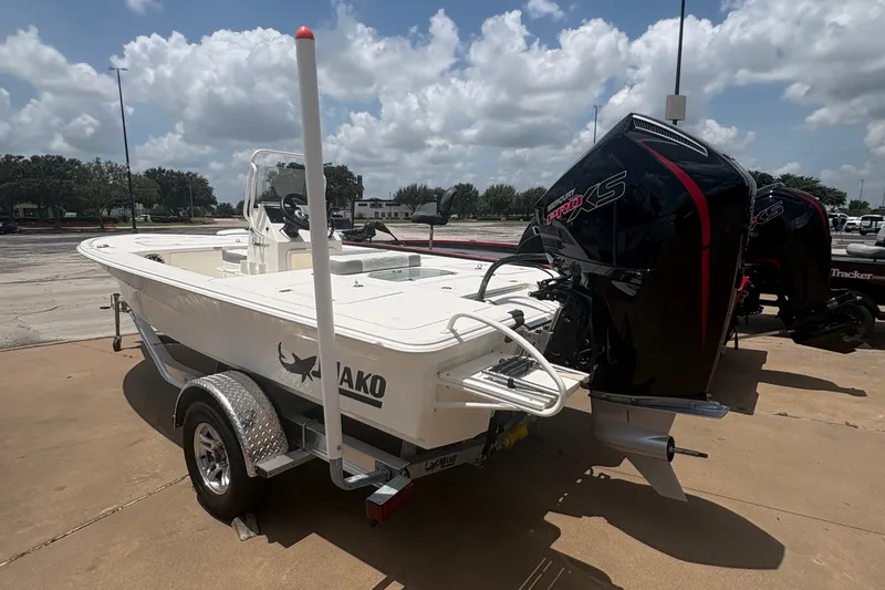 Slide: The Image of 2026 Mako 18 Pro Skiff boat on trailer under a clear blue sky. - 3