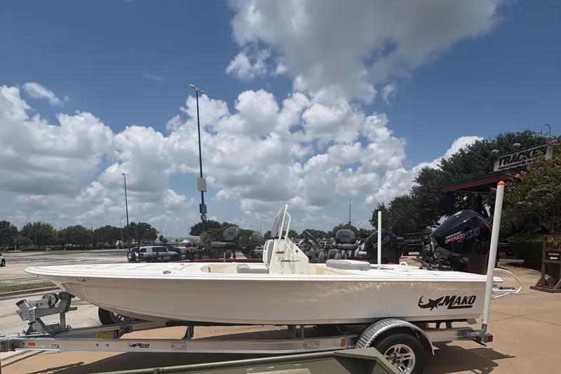 Slide: The Image of 2026 Mako 18 Pro Skiff boat on trailer under a partly cloudy sky. - 4