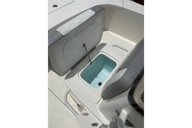Slide: The Image of Open storage compartment on 2026 Mako 18 Pro Skiff boat, showcasing interior design. - 13