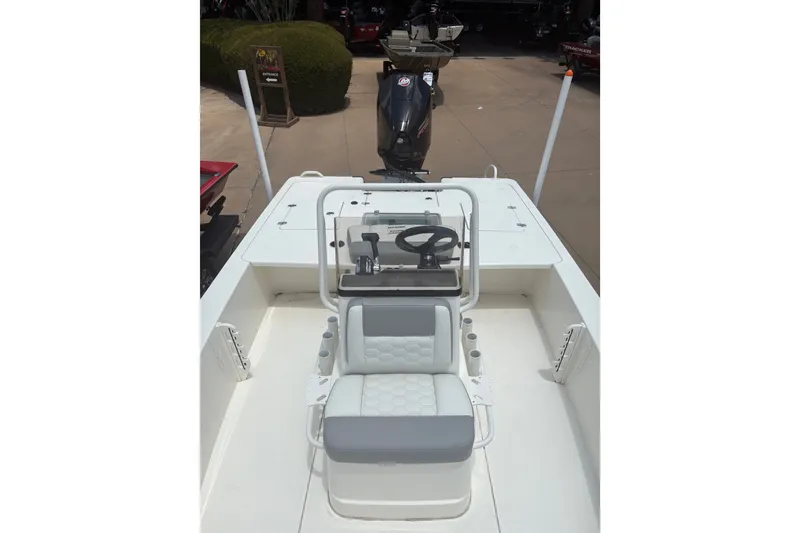 Slide: The Image of 2026 Mako 18 Pro Skiff boat interior with steering console and seating. - 10