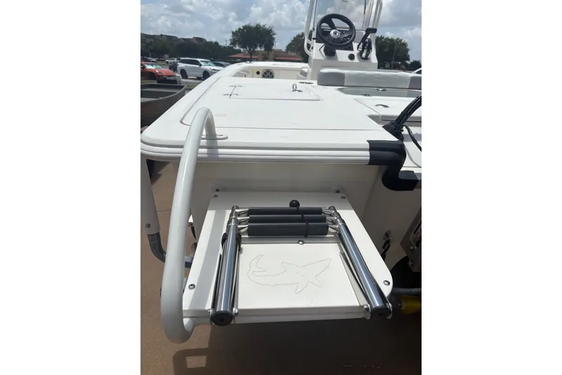 Slide: The Image of 2026 Mako 18 Pro Skiff boat with foldable ladder and steering console. - 22
