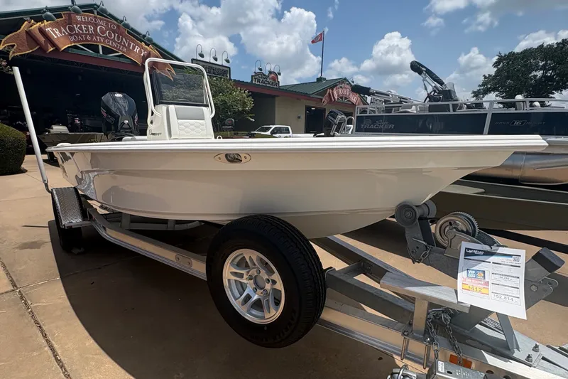 Slide: The Image of 2026 Mako 18 Pro Skiff boat on trailer under clear blue sky. - 9