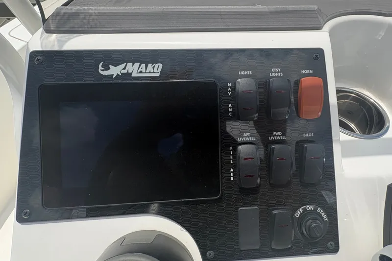 Slide: The Image of Control panel of 2026 Mako 18 Pro Skiff boat with switches and display. - 17