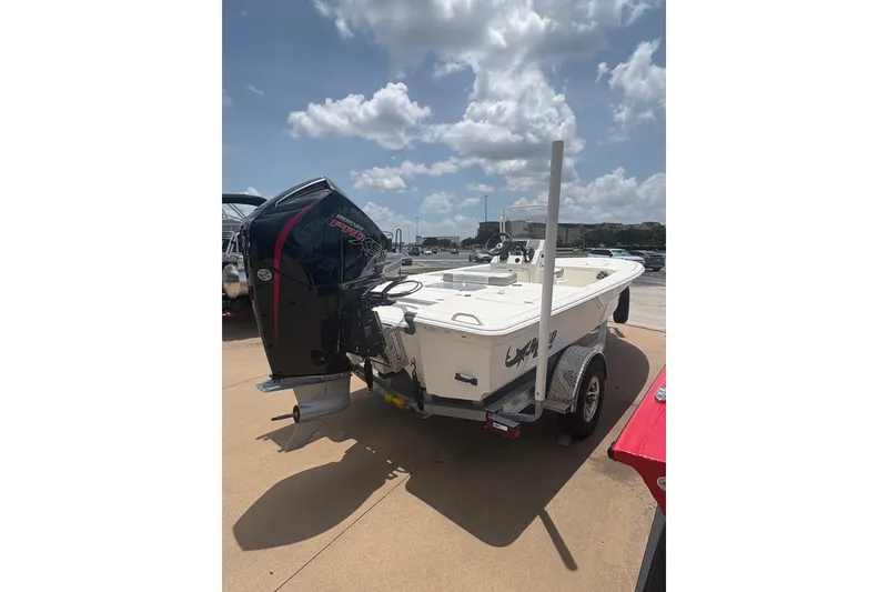 Slide: The Image of 2026 Mako 18 Pro Skiff boat on trailer under a sunny sky. - 7