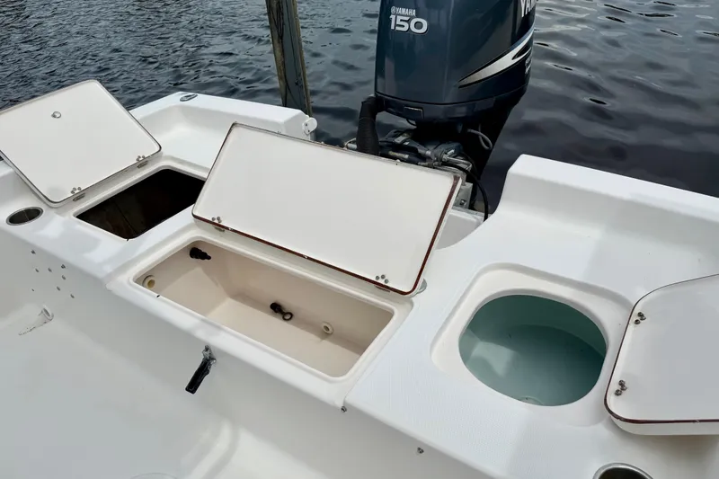 Slide: The Image of 2007 Sea Hunt BX 21 T boat with open storage compartments and Yamaha 150 outboard motor. - 12