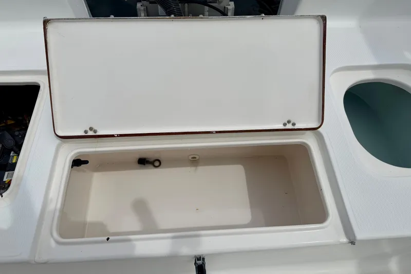Slide: The Image of Open storage compartment on a 2007 Sea Hunt BX 21 T boat. - 14