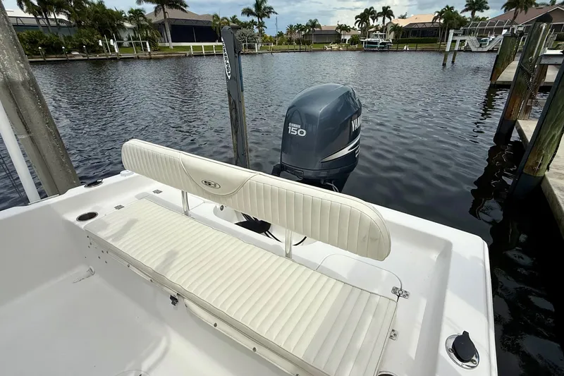 Slide: The Image of 2007 Sea Hunt BX 21 T boat with Yamaha 150 engine docked by waterfront homes. - 16