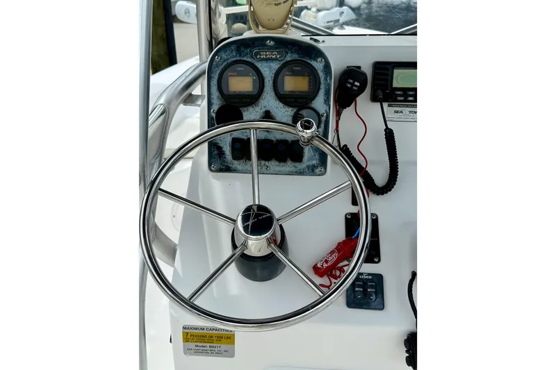 Slide: The Image of 2007 Sea Hunt BX 21 T boat dashboard with steering wheel and control panel. - 20