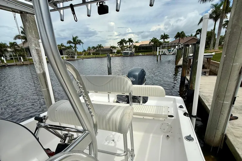 Slide: The Image of 2007 Sea Hunt BX 21 T boat docked by a scenic waterfront with palm trees. - 22