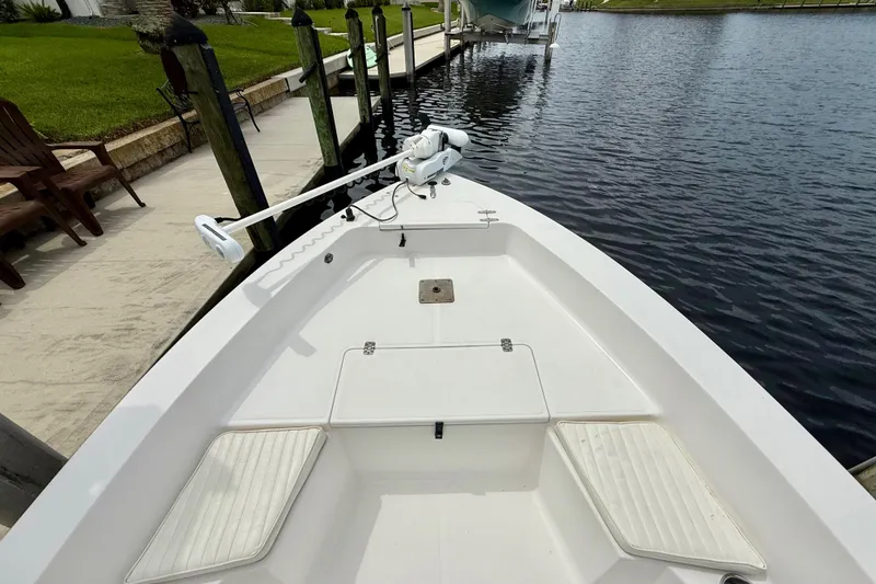 Slide: The Image of 2007 Sea Hunt BX 21 T boat docked by a calm waterfront. - 24