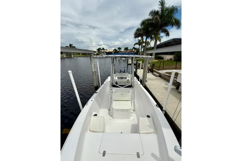 Slide: The Image of 2007 Sea Hunt BX 21 T boat docked by a canal with palm trees. - 26