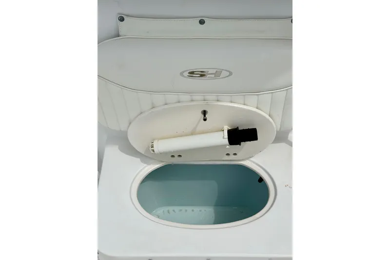 Slide: The Image of 2007 Sea Hunt BX 21 T boat livewell with open lid and white interior. - 28