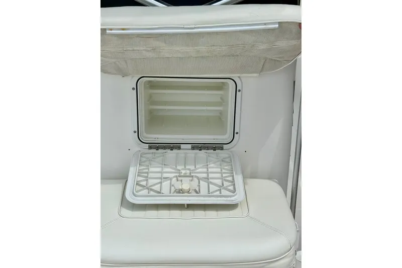 Slide: The Image of 2007 Sea Hunt BX 21 T boat storage compartment with open lid, showcasing interior space. - 29
