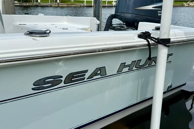 Slide: The Image of 2007 Sea Hunt BX 21 T boat docked by the water. - 34