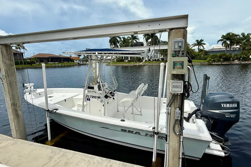 Slide: The Image of 2007 Sea Hunt BX 21 T boat docked with Yamaha motor, scenic waterfront view. - 5