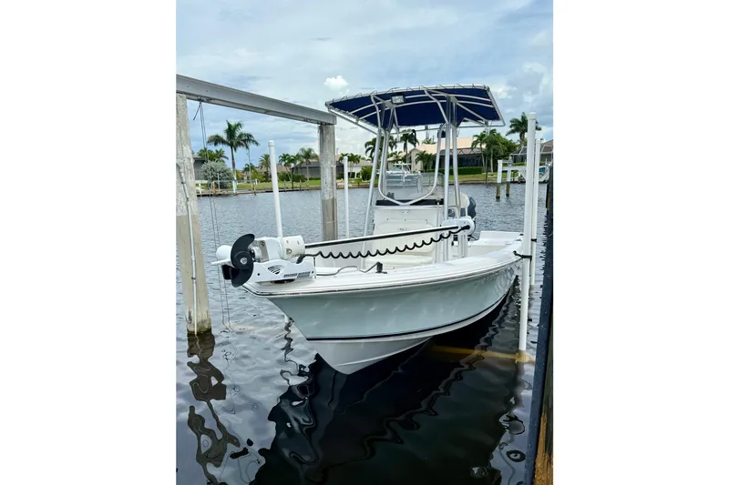 Slide: The Image of 2007 Sea Hunt BX 21 T boat docked on calm water with canopy. - 6