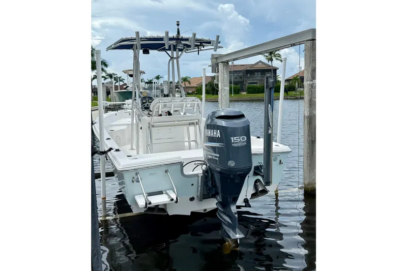 Slide: The Image of 2007 Sea Hunt BX 21 T boat with Yamaha 150 engine docked by waterfront homes. - 7