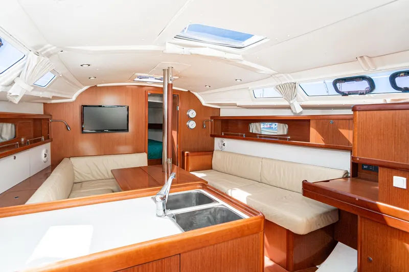 Slide: The Image of Interior of 2011 Beneteau Oceanis 37 yacht with modern wood finish and comfortable seating. - 10