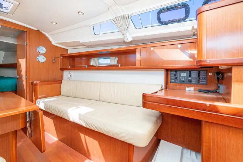 Slide: The Image of Interior of 2011 Beneteau Oceanis 37 yacht with wooden finish and beige seating. - 13