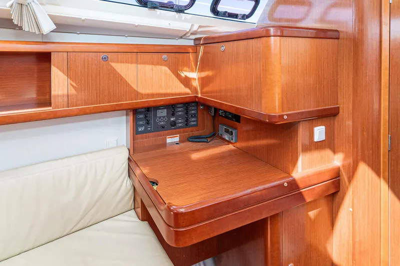 Slide: The Image of Interior of 2011 Beneteau Oceanis 37 yacht with wooden cabinetry and navigation panel. - 14