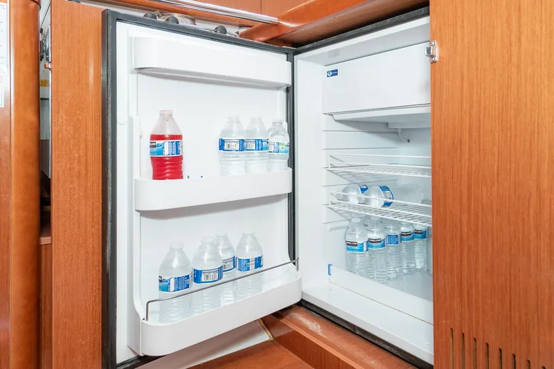 Slide: The Image of Refrigerator stocked with water bottles inside a 2011 Beneteau Oceanis 37 sailboat. - 19
