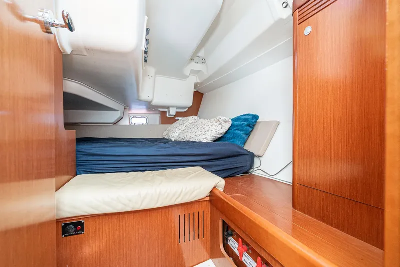 Slide: The Image of Cozy cabin interior of 2011 Beneteau Oceanis 37 sailboat with wooden finish and bedding. - 22