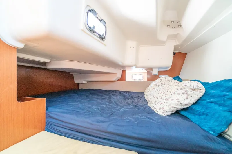 Slide: The Image of Cozy cabin interior of 2011 Beneteau Oceanis 37 sailboat with blue bedding. - 23