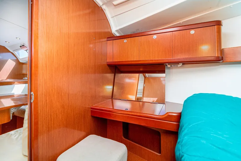 Slide: The Image of Interior of 2011 Beneteau Oceanis 37 yacht with wooden cabinetry and cozy seating area. - 26