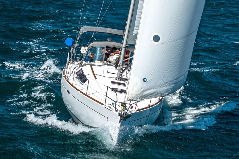 Slide: The Image of 2011 Beneteau Oceanis 37 sailing on open sea with full sails. - 3