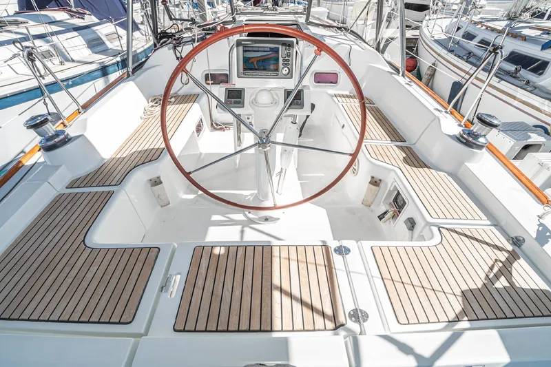 Slide: The Image of Cockpit of 2011 Beneteau Oceanis 37 sailboat with wooden deck and steering wheel. - 30