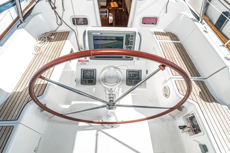 Slide: The Image of Cockpit of 2011 Beneteau Oceanis 37 sailboat with navigation instruments and wooden steering wheel. - 31