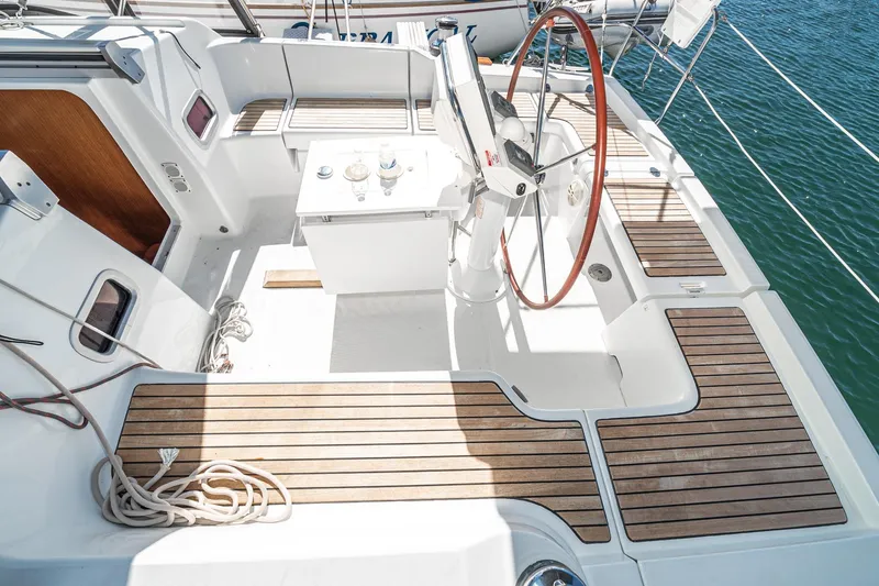 Slide: The Image of Cockpit of 2011 Beneteau Oceanis 37 sailboat with wooden deck and steering wheel. - 32