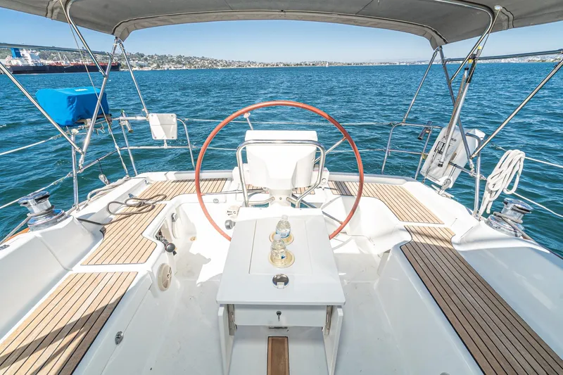 Slide: The Image of 2011 Beneteau Oceanis 37 sailboat cockpit with wooden deck and ocean view. - 33