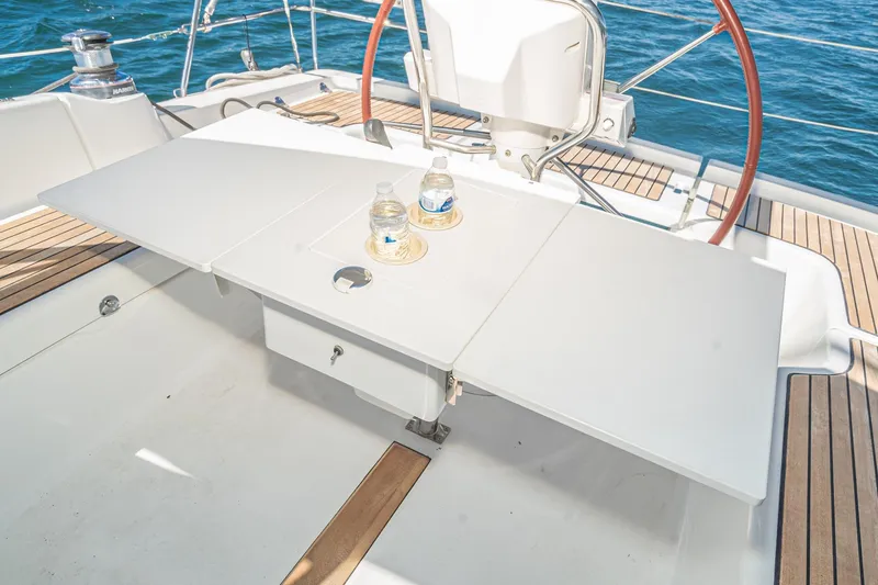 Slide: The Image of Cockpit of 2011 Beneteau Oceanis 37 sailboat with table and steering wheel. - 34