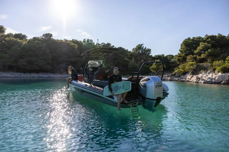 Slide: The Image of 2026 Highfield ADV7 boat on clear water, people relaxing, surrounded by lush greenery. - 5