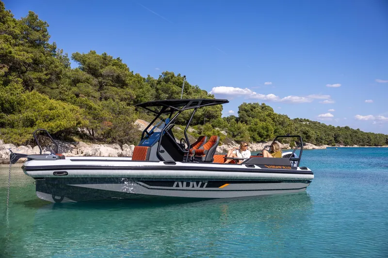 Slide: The Image of 2026 Highfield ADV7 boat on clear turquoise water, surrounded by lush greenery. - 9