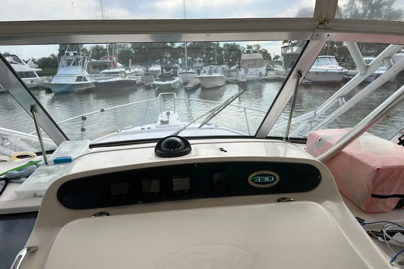 Slide: The Image of 2008 Grady-White Express 330 boat seat with white upholstery and sleek design. - 25