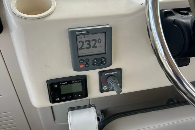 Slide: The Image of 2008 Grady-White Express 330 boat interior with beige seating and control panel. - 26