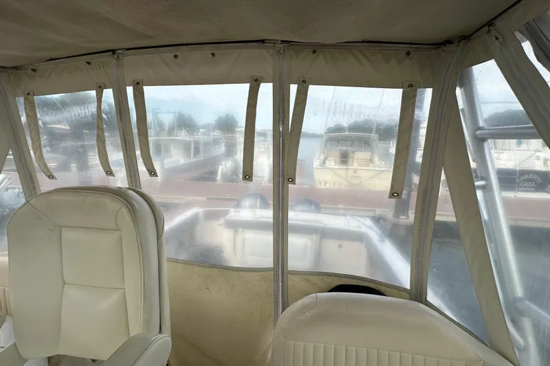 Slide: The Image of 2008 Grady-White Express 330 boat interior with cream seating at marina. - 27