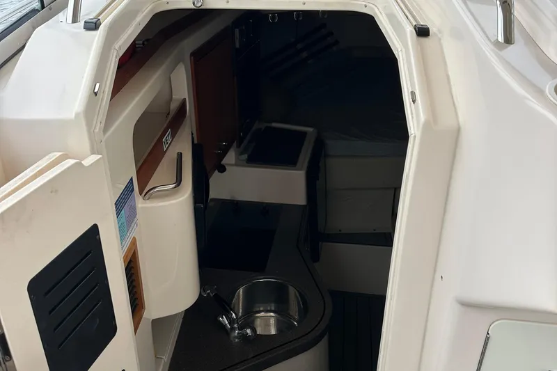 Slide: The Image of 2008 Grady-White Express 330 cabin interior with sink and compact layout. - 40