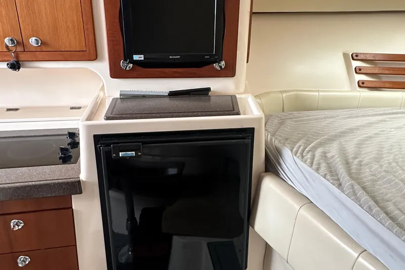 Slide: The Image of 2008 Grady-White Express 330 cabin interior with kitchenette and bed. - 42
